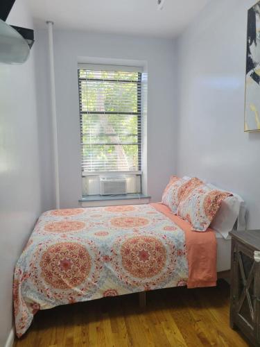 a bedroom with a bed and a window at The Harlem Getaway in New York