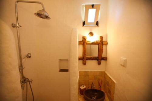 a bathroom with a sink and a shower at Casa Amado, Aldeia da Pedralva in Vila do Bispo