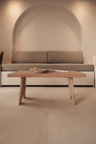 a wooden coffee table in front of a couch at Om Living Afitos in Afitos