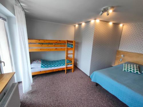 a small bedroom with two bunk beds in it at Kasztanowe Wrota in Kosewo