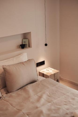 a bedroom with a bed and a wooden table at Om Living Afitos in Afitos