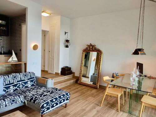 a living room with a couch and a mirror at My Space on the Beach, Luxury Apartment in Casares
