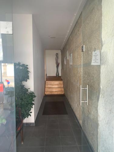 a hallway with a staircase in a building at Residencial Encontro in Vila Real
