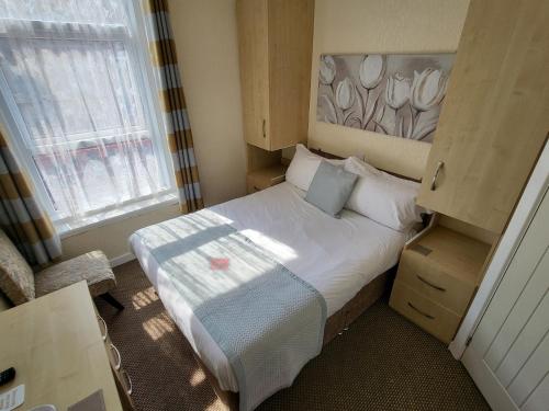 a small bedroom with a bed and a window at The Lumada in Blackpool