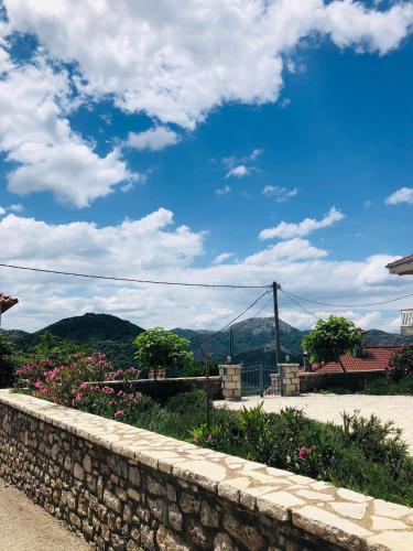 a stone wall with a view of the mountains at Stonehouse dome Lagadia in Lagadia