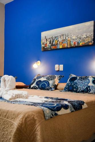 a blue room with two beds with pillows on them at Hotel Ciudad del Sol in Termas de Río Hondo
