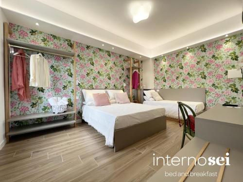 1 Schlafzimmer mit 2 Betten und Blumentapete in der Unterkunft Interno Sei B&B in Agropoli
