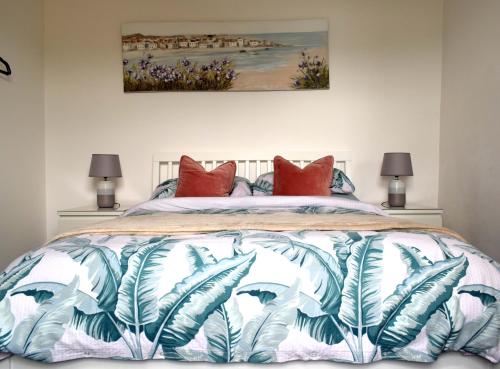 una camera da letto con un letto con cuscini rossi di The Old Fishermans Lookout a Falmouth