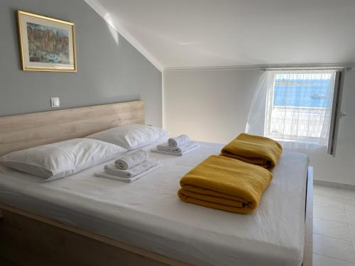 a bedroom with a bed with towels on it at Emanuela 2 in Novalja