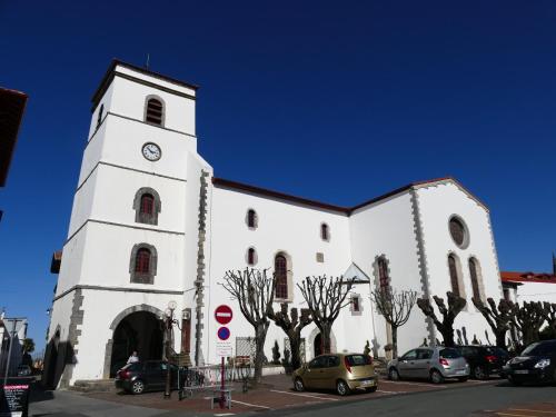 a large white church with a clock tower at Le pied-à-terre hendayais in Hendaye