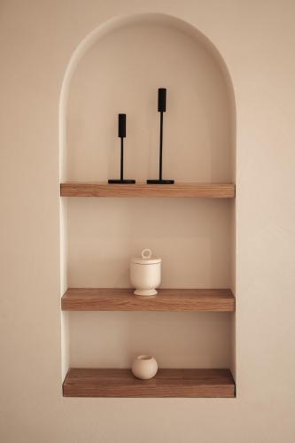 a shelf with two black objects and a bowl on it at Om Living Afitos in Afitos