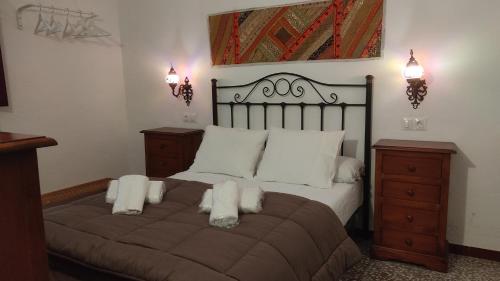 a bedroom with a large bed with white pillows at Casa de la abuela Tere Caminito del Rey, Valle de Abdalajís, Málaga in Valle de Abdalagís