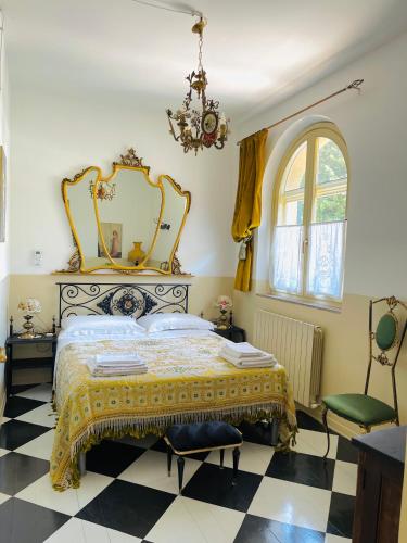 a bedroom with a bed with a mirror and a chair at Mapepa Village apartments in Spello
