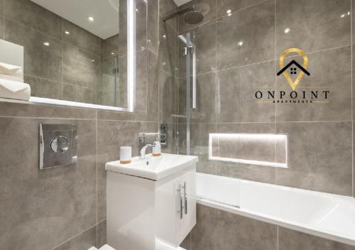 a bathroom with a toilet and a sink and a tub at ✰OnPoint - Fantastic 1 Bedroom Apt with PARKING✰ in Reading