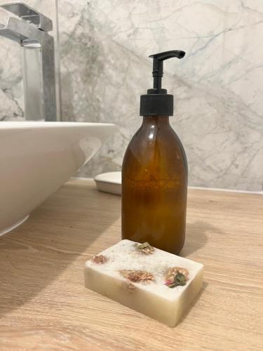 a bottle of soap sitting on a counter next to a sink at Stunning location on Pendle Hill in Nelson