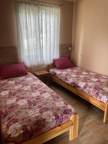 a bedroom with two beds and a window at Комплекс Омайник in Kalofer