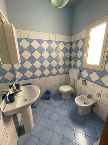 a bathroom with a sink and a toilet at Case Porta San Salvatore Sciacca in Sciacca