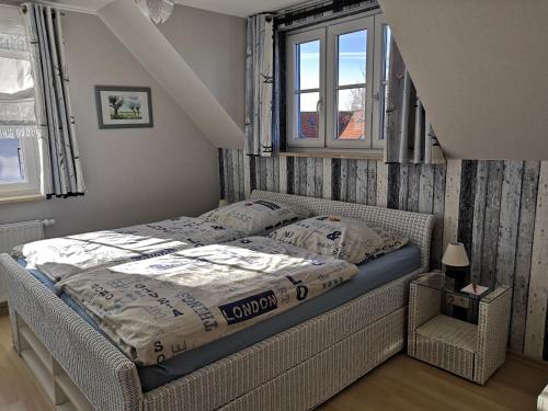 a bedroom with a bed in a room with windows at Ferienwohnung Seeanemone I in Graal-Müritz