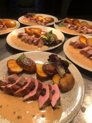 a bunch of plates of food on a table at Hotel Mlyn - Jihlava in Vílanec