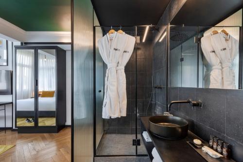 a bathroom with a sink and a mirror at Theodor Brown Rothschild Tel-Aviv, a member of Brown Hotels in Tel Aviv