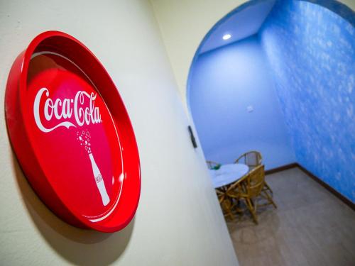 a cocacola sign on the side of a wall at Gather Here 62 5BR Town Center 5 Rooms in Taiping