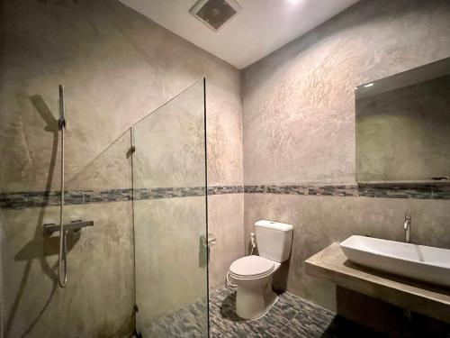 a bathroom with a shower and a toilet and a sink at B3 Hotel in Nakhon Si Thammarat