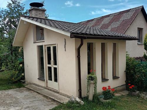 a small white house with a red roof at Apartmán u Anny in Štrba