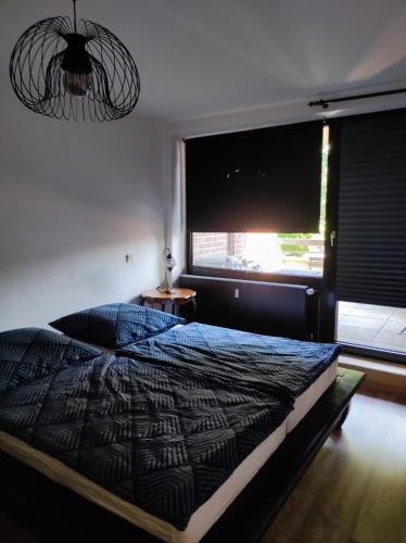 a bedroom with a bed and a large window at Am Zwischenahner Meer in Bad Zwischenahn