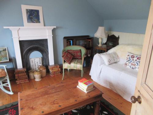 a bedroom with a bed and a fireplace at Anchor House in Pittenweem