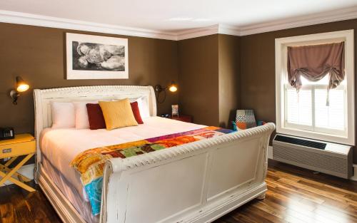 a bedroom with a white bed and a window at Logan Inn in New Hope