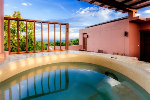 an indoor pool with a view from a house at Phukumhom Khao Yai in Wangkata