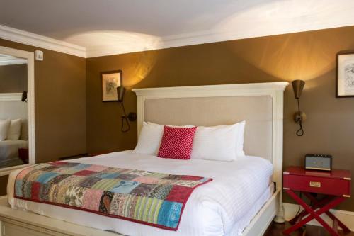 a bedroom with a white bed with a red pillow at Logan Inn in New Hope