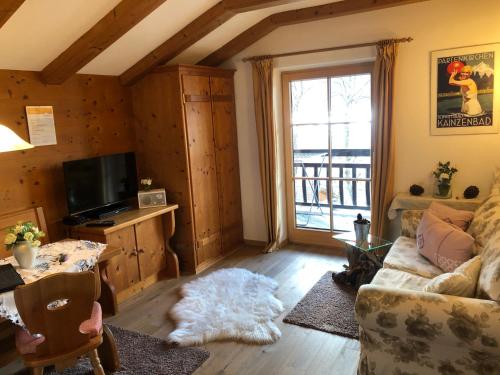 a living room with a couch and a table at Ferienhaus Heimhof in Garmisch-Partenkirchen