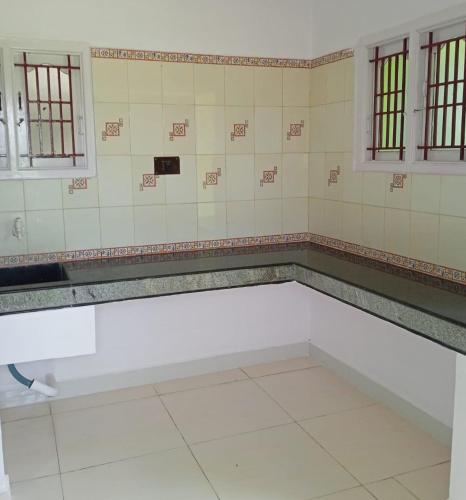 a room with a white bench in a bathroom at Criston Home stay in Madurai