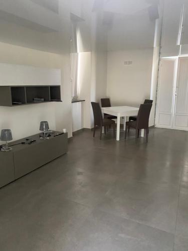 a dining room with a table and chairs in a room at Villa Rosa in Ischia