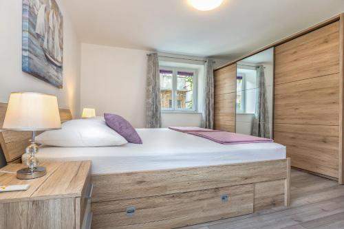 a bedroom with a large bed and a desk at TORETA Apartment - city center, beachfront in Omiš
