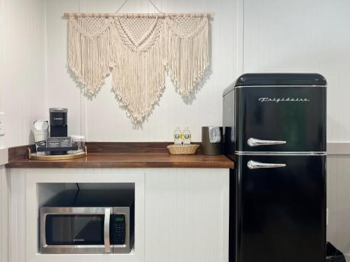 a kitchen with a black refrigerator and a microwave at Hotel Cashiers in Cashiers