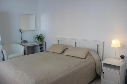 a bedroom with a bed and a table and a chair at LEO Apartment FREE PARKING!!! in Bratislava