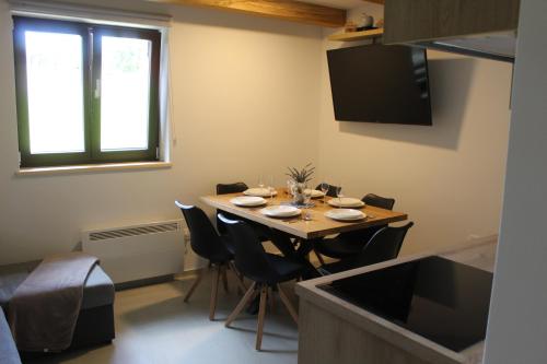 a dining room with a table with chairs and a window at Apartment Bajta - Rogla in Zreče