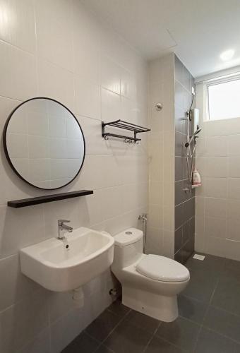 a bathroom with a sink and a toilet and a mirror at Austin @ Novo 8 in Malacca