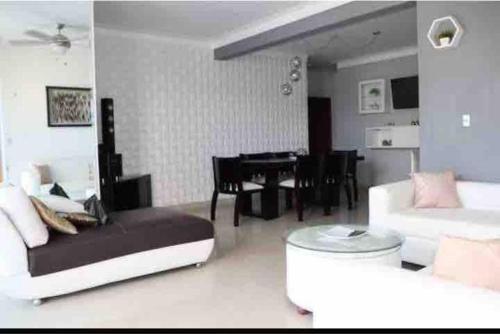 a living room with a couch and a table at Self check in , moderno, A/C completo Wifi, TV 4K in Santiago de los Caballeros