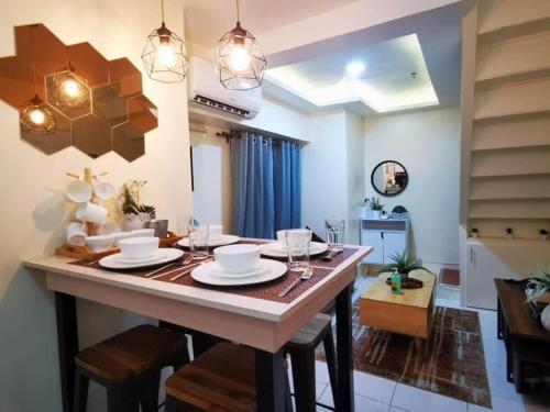 a dining room and living room with a table and chairs at Amazing Condo @ the heart of Manila in Manila