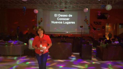 a woman standing on a dance floor in front of a stage at Kajaca Suite Hotel in Huacho