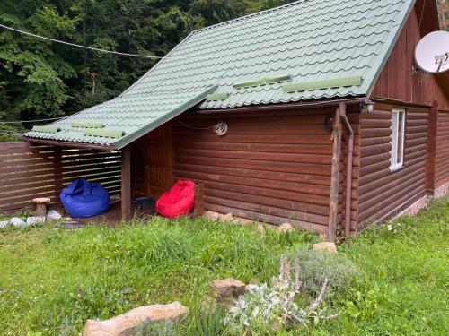 a cabin with two bags sitting outside of it at Vilni Vitry in Osmoloda