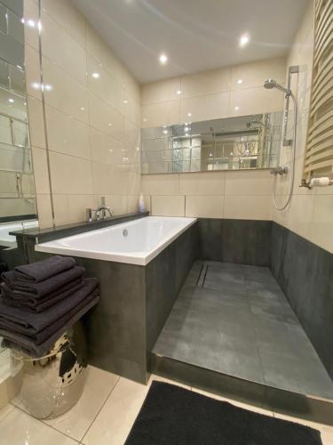 a large bathroom with a tub and a shower at Apartament w sercu Gdańska z parkingiem podziemnym in Gdańsk