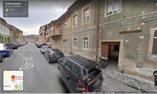a street with cars parked on the side of a building at Ada's Luxury Apartament&Studio - Old City in Braşov