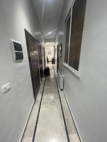 a long hallway with a door and a hallway sidx sidx at Appartemet haut standing in Tunis