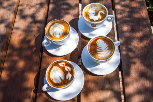 a group of three cups of coffee on a table at Temple Tree Resort & Spa, Pokhara in Pokhara