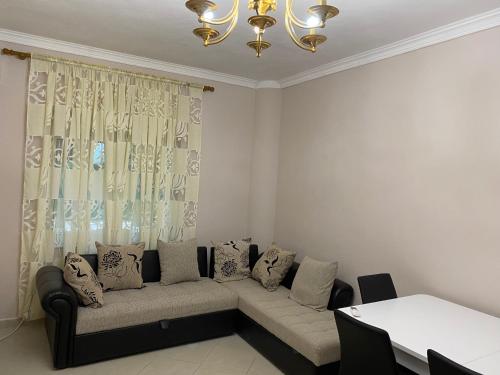a living room with a couch and a chandelier at Coastal, 2-bedroom rental unit in Golem