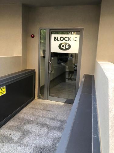 a sign on the door of a black and white store at Brand new apartment 2 mins from Seafront in St Paul's Bay